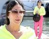Cher stands out from the crowd in a luminous green hoodie and hot pink ...
