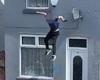 Shocking moment man leaps from roof of two-storey building 'in bid to get away ...