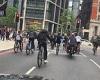 Shocking moment dozens of bike riders pull wheelies and run red light in ...