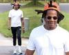 Jay-Z flashes a smile as he enjoys a walk near his Hamptons vacation home ...