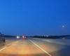 Fiery meteor streaks across the sky above a Texas highway