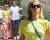 Paris Hilton flashes her flat abs in a yellow crop top as she holds hands with ...