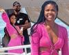 Gabrielle Union rocks a neon pink cut-out dress as she enjoys luxurious holiday ...