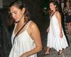 Gal Gadot puts on a stylish display in a plunging white maxi dress as she heads ...