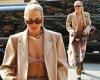 Rita Ora showcases her toned abs in a sheer veil and beige bra as she steps out ...