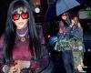Rihanna rocks a camouflage skirt over matching pants as her bodyguard CARRIES ...