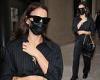 Irina Shayk is the picture of elegance in a black pinstripe shirt during Milan ...