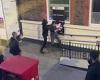 Moment two people grapple at cash machine