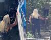 Dog the Bounty Hunter wades through waist-deep Florida swamp waters in the hunt ...
