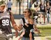 NRL star Tom Burgess and fiancée Tahlia Giumelli enjoy a walk with their ...