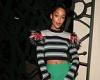 Laura Harrier flashes her taut midriff in a feathered jumper and mini skirt