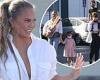 Chrissy Teigen rocks a plunging white button-down while grocery shopping with ...