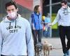 Hugh Jackman walks his dogs while chatting with a friend in New York City 