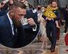 Conor McGregor carries his daughter during the christening of his son Rían at ...