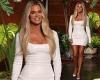 Khloe Kardashian wears a figure-hugging white dress as she steps out onto The ...