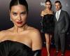 Adriana Lima stuns in LBD with leather gloves  while joined by Andre Lemmers at ...