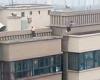 Heart-stopping moment two boys leap across roofs on a 22-storey building in ...