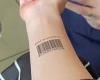 Woolworths shopper tests out her barcode tattoo at the supermarket