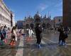 Tourists wade through water in St. Mark's square after Venice floods again