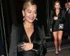 Rita Ora turns heads in a sizzling black satin dress and purple heels as she ...