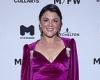 Em Rusciano turns heads in a low-cut purple dress at Melbourne Fashion Week