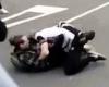 Two men brawl in vicious broad daylight street fight as onlookers gather round ...