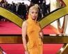 FKA twigs wows in dramatic orange hooded gown