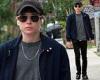 Elliot Page oozes casual-cool while rocking out to music through earbuds during ...