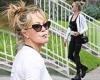 Melanie Griffith puffs on a cigarette while rocking an athletic look before ...