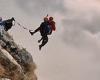 Duo base jump from a 3,280-foot Italian mountain into a fog-filled valley