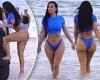 Kim Kardashian showcases her famous hourglass curves in a bright blue bikini ...