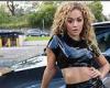 Rita Ora shows off her abs in racy black PVC crop top and thigh-high split skirt