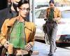 Bella Hadid pairs a cropped sweater with baggy slacks as she holds on to an ...
