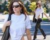 Julia Fox struts her stuff in a white shirt and vinyl pants while walking ...