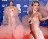 Florence Pugh commands attention in a pink satin dress with a dramatic sheer ... trends now