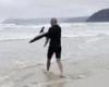 Surfer picks up beached shark and carries creature back to the water in Victoria trends now
