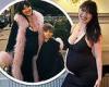 Pregnant Daisy Lowe cradles her growing baby bump in a plunging black maxi dress trends now
