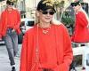 Gigi Hadid flashes a peace sign while wearing a bright red sweater set as she ... trends now