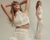 Abbey Clancy flashes her toned physique in a cream crop top as she poses for ... trends now