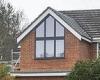 Pain in the glass! Neighbours at war after couple builds 10ft 'church' window ... trends now