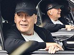 Bruce Willis smiles in rare sighting as he dons Dodgers cap on drive with bodyguard in LA amid aphasia and dementia battle